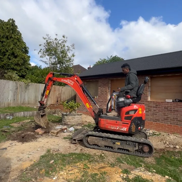 Mini excavator clearing the back garden of a house in Ickenham ahead of an extension