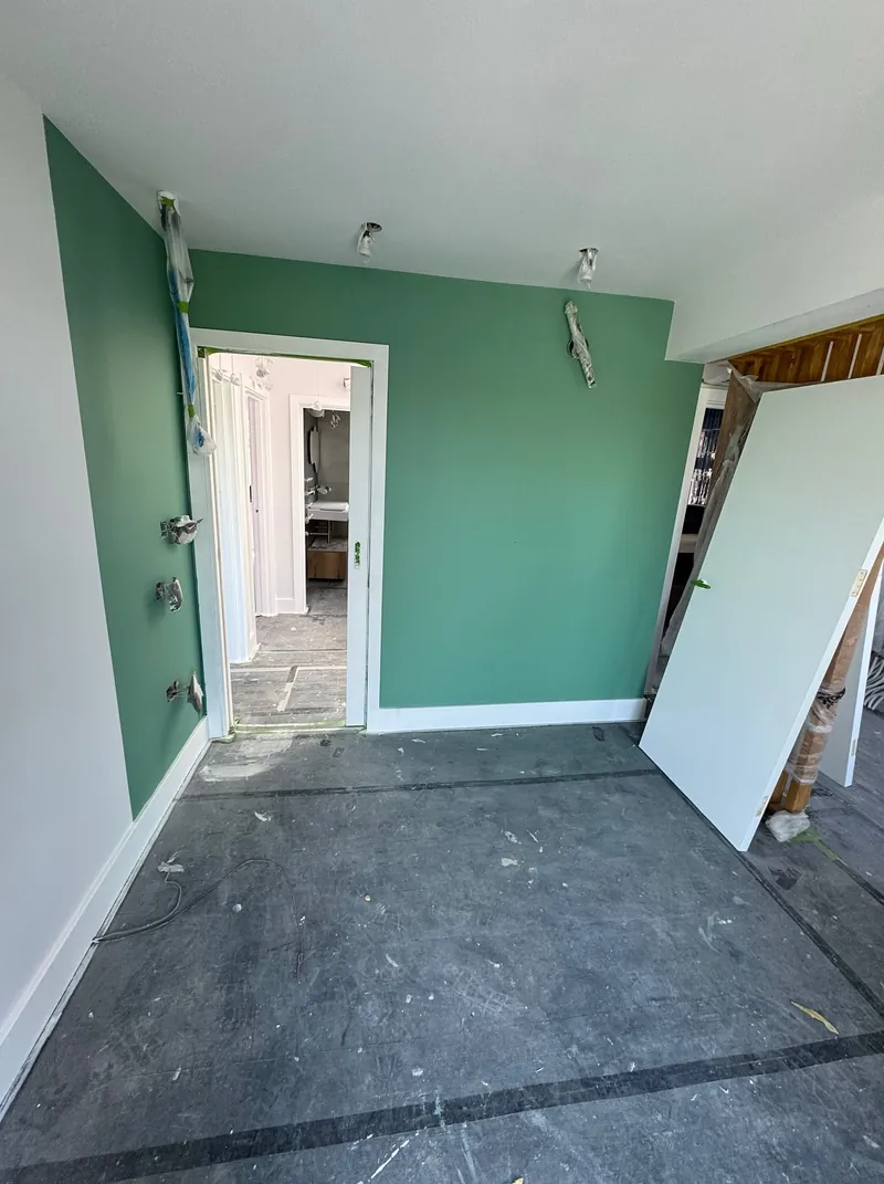 First-floor room in Wembley with a newly painted green feature wall