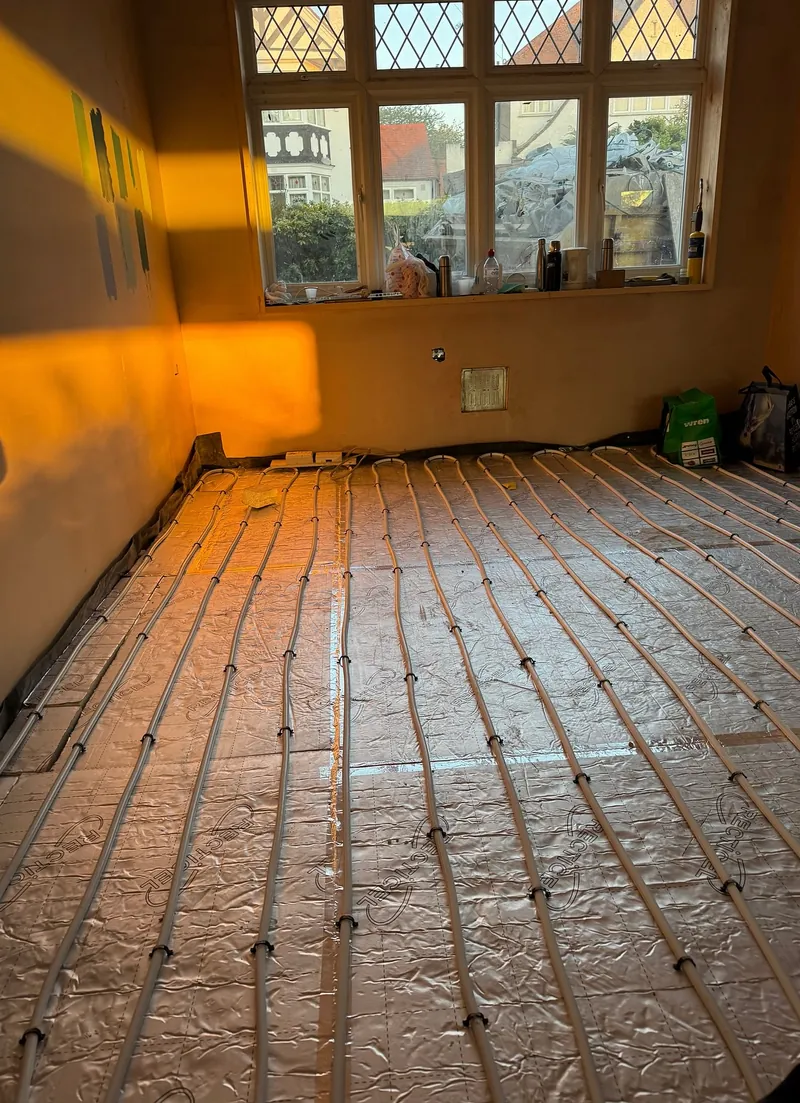 First floor in Wembley with insulation, underfloor heating pipes and newly levelled screed